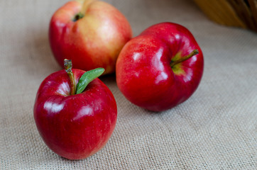 Ripe red apples on gray cloth