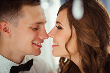 Closeup of lovely wedding couple touching eahc other noses