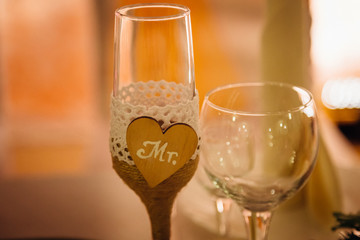 Wooden heart with lettering Mr decorates champagne flute