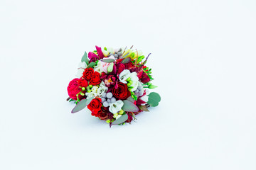 Wedding bouquet made of red and white flowers, decorated with gr