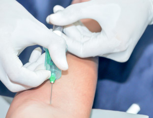 Laboratory with nurse taking a blood sample from patient,close up and soft focus