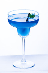 Cocktail blue lagoon on a white background.With a straw and candy . Alcoholic cocktail