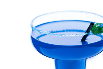 Cocktail blue lagoon on a white background.With a straw and candy . Alcoholic cocktail