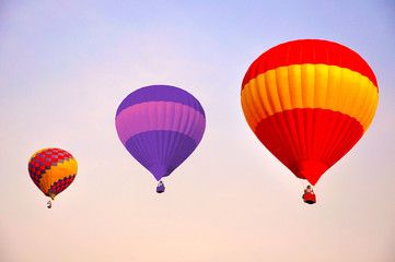 Colorful hot air balloons flying at sunrise