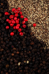 whole, crashed and ground black and red peppercorns