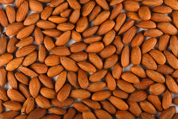 Pile of almonds close-up as abstract food background