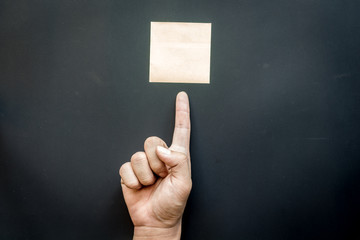Hand with reminder sticky note ,empty space for text