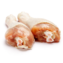 Raw chicken legs on a white background