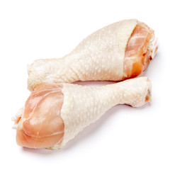 Raw chicken legs on a white background