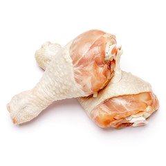 Raw chicken legs on a white background