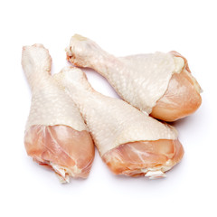 Raw chicken legs on a white background