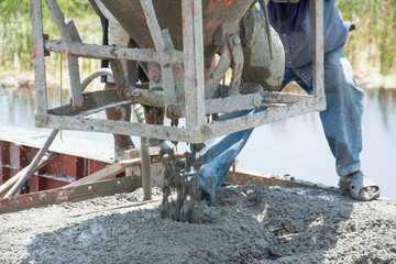 worker pouring  concrete  works at construction site