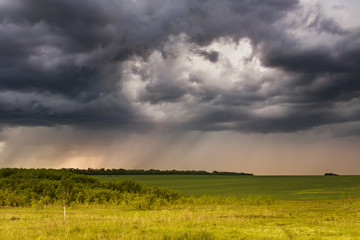 rural landscape with the storm sky and a rain