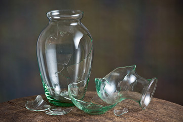 broken glass vase on old wood table