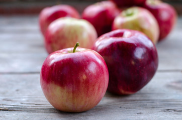 Ripe apples on a gray wooden table