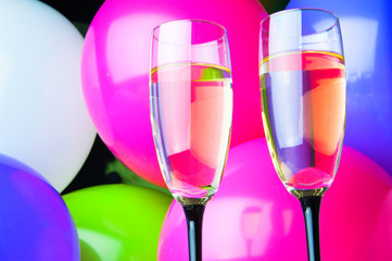 Two glasses of champagne and balloons on party