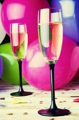 Two glasses of champagne and balloons on party