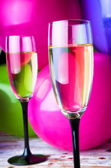 Two glasses of champagne and balloons on party