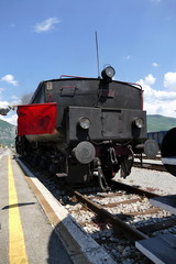 Fototapeta na wymiar Steam locomotive connecting vagons with red flag