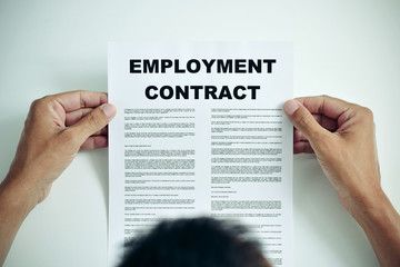 man reading an employment contract