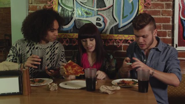 Three friends eating pizza - 4K