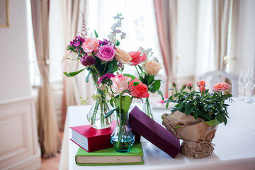 Fototapeta na wymiar Wedding banquet, small restaurant floral, decor in red, informal style.