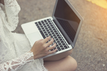 lady hand use laptop in garden.