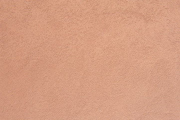 Salmon pink rough concrete wall background