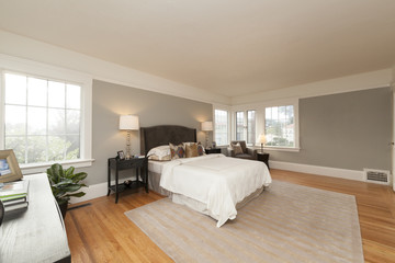 Fototapeta na wymiar Modern Bedroom with Full Bed and Wooden Floors