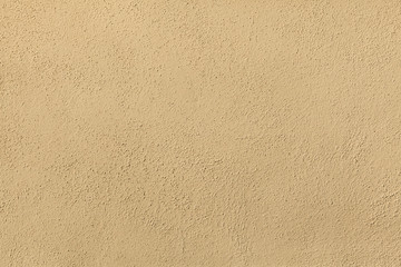 Yellow painted stucco wall. Background texture