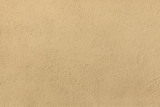 Yellow painted stucco wall. Background texture