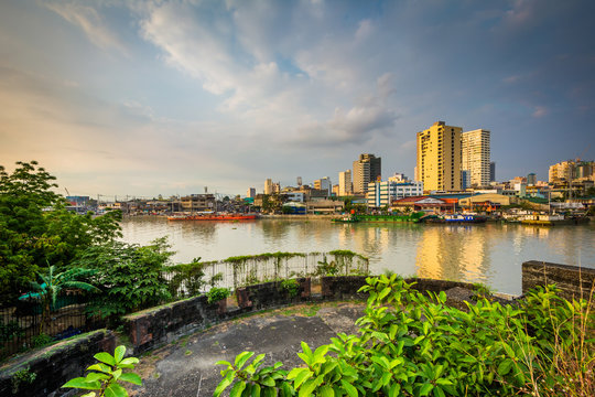 Ruins at Fort Santiago and buildings along the Pasay River, in I
