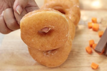 Donut topped sugar delicious on wood background.