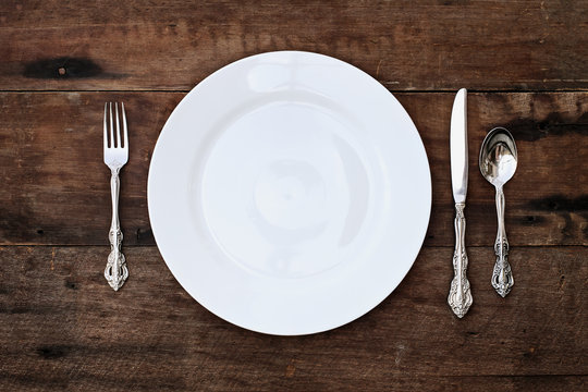 Place setting of a dining set over rustic background