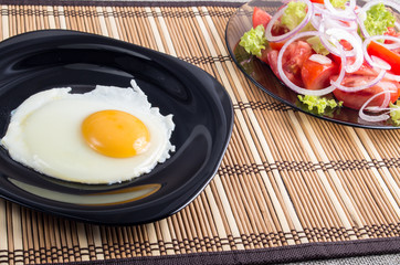 Natural homemade breakfast of fried egg and salad