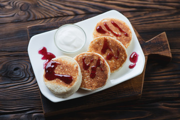 Curd pancakes on a rustic wooden background, high angle view