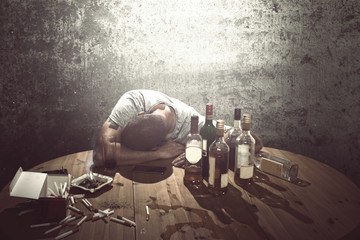Drunk man sleeping on table