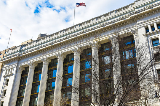 Front View Of American Bar Association Building In Washington DC With American Flag Flying.