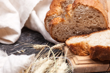 Rustic bread on wood table. Dark wooden background