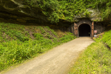 Fototapeta na wymiar Bike Trail Tunnel / A bike trail passing through a former railroad tunnel.