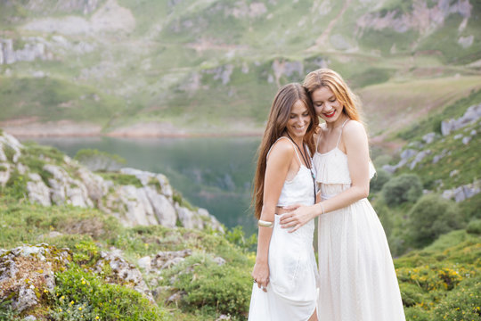 Happy best friends in white clothes against of natural background