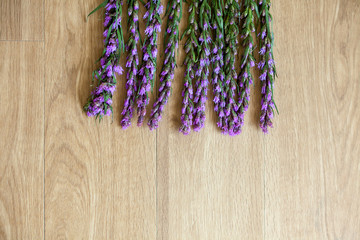 Obraz na płótnie Canvas Violet Lavender flowers on top frame on brown wood background - with copy space