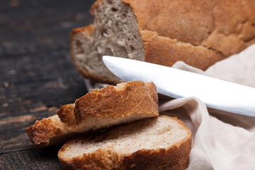 Rustic bread on wood table. Dark woody background with free text space.