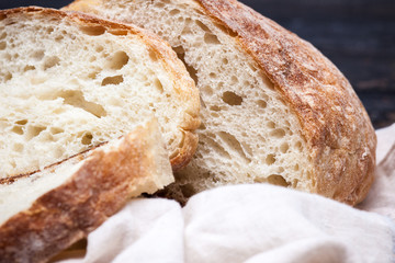 Rustic bread on wood table. Dark wooden background