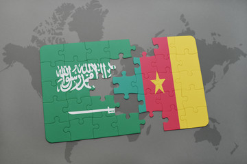 puzzle with the national flag of saudi arabia and cameroon on a world map background.