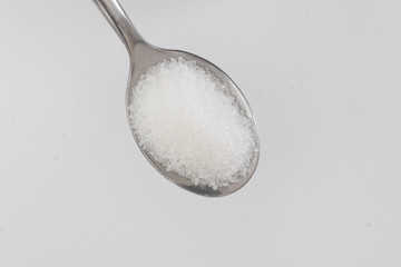 spoon of sugar on a white background