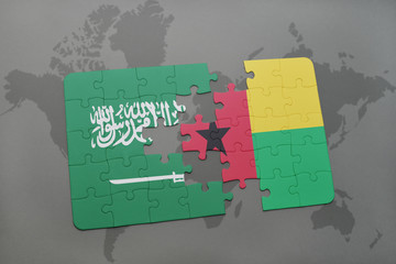 puzzle with the national flag of saudi arabia and guinea bissau on a world map background.