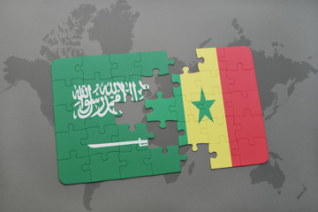 puzzle with the national flag of saudi arabia and senegal on a world map background.