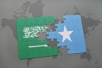 puzzle with the national flag of saudi arabia and somalia on a world map background.