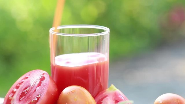 Tomato juice is poured into a glass